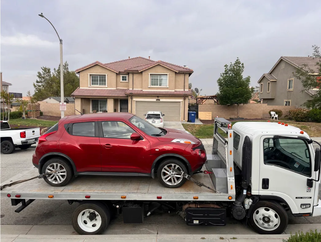 Lotus Towing flatbed truck picking up vehicle in Palmdale CA
